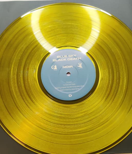 Close up of yellow vinyl (side C and D) of 10-year anniversary pressing of Blue Sky Black Death's Noir.