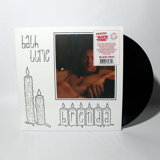 Vinyl record with cover featuring a person and candles on a white background