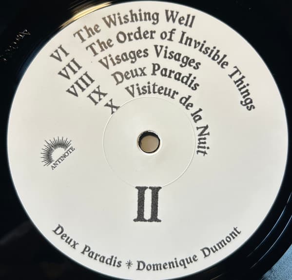 Vinyl record label with text and a logo on a white background