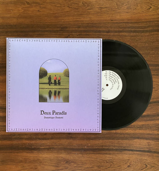 Vinyl record with cover for Domenique Dumont - Deux Paradis on a wooden surface