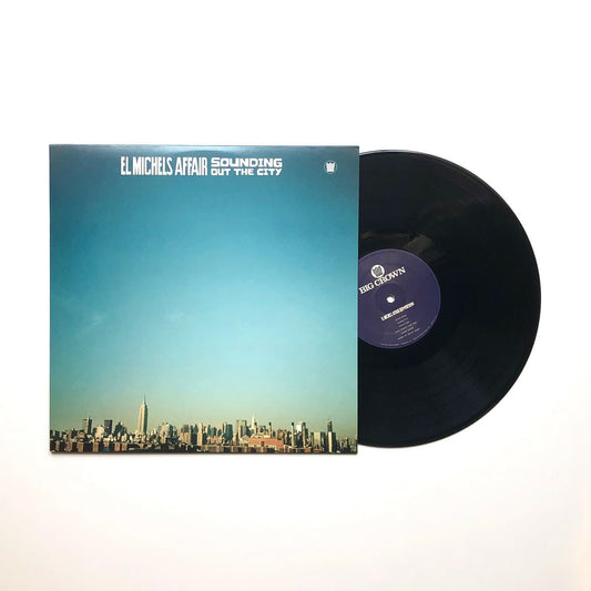 Vinyl record with cover featuring a cityscape design on a white background