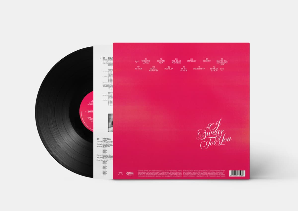 Vinyl record with a pink cover featuring text on a white background