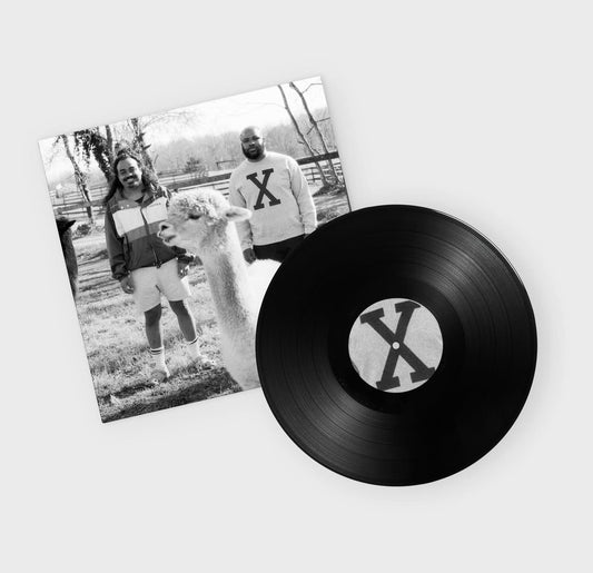 Close up of vinyl and album cover for A City Drowned in God's Black Tears by Infinity Knives & Brian Ennals featuring Brian Ennals and Infinity Knives standing with a fluffy animal in an outdoor setting