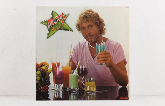 Marcos Valle’s 1983 self-titled album reissued by Mr Bongo, featuring pink-shirted Valle on the cover surrounded by neon cocktails; available on black vinyl.