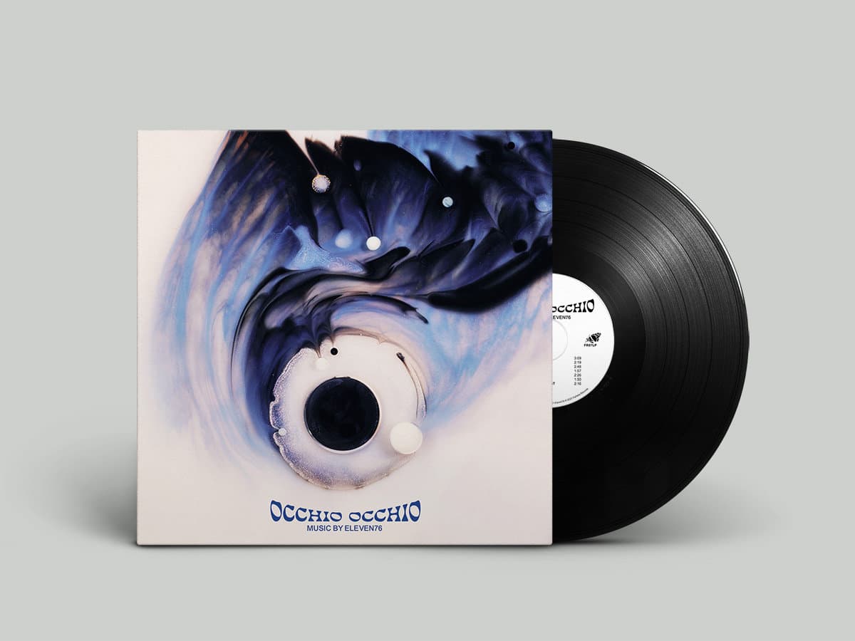 Vinyl record with a cover featuring artistic design on a gray background