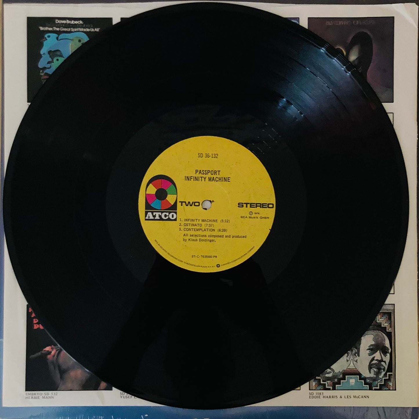 Vinyl close-up of Infinity Machine record by Passport, condition VG+