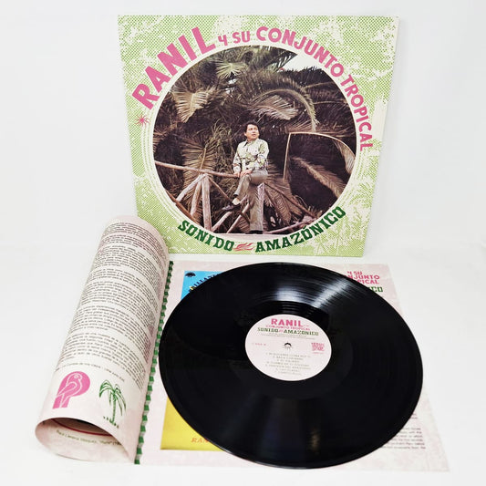 Vinyl record with cover for Ranil y Su Conjunto Tropical - Sonida Amazónico featuring a person and tropical design, on a white background