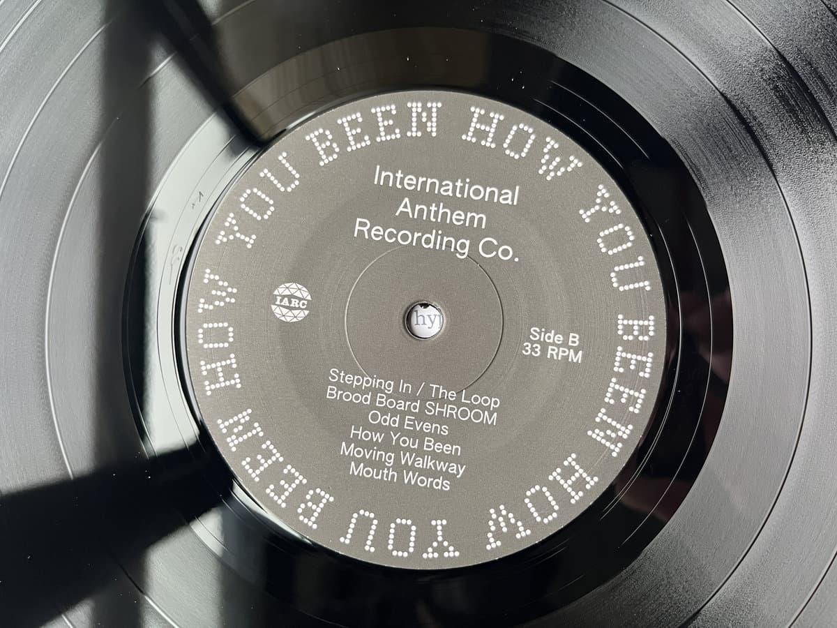 Close-up of a vinyl record label with text and branding.