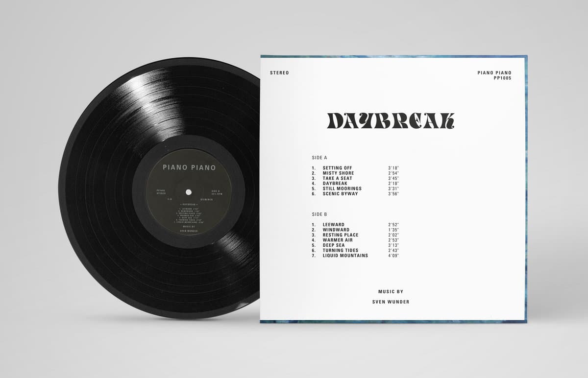 Vinyl record with cover displaying album details on a gray background