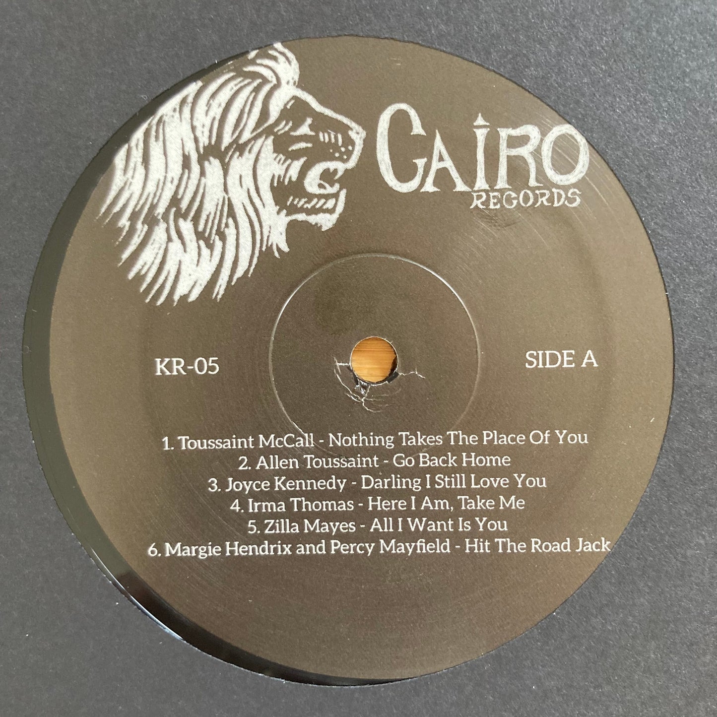 Vinyl label, side A, for “The World Is a Cafeteria” 2LP soul compilation by Cairo Records. Gold foil detail, white sleeves, deluxe packaging with booklet.