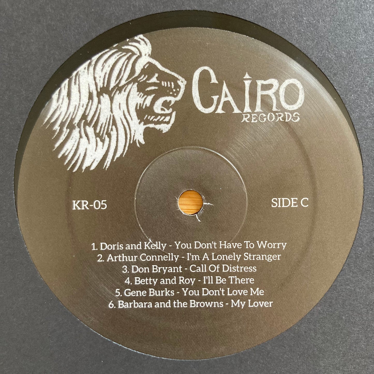 Vinyl label, side C, for “The World Is a Cafeteria” 2LP soul compilation by Cairo Records. Gold foil detail, white sleeves, deluxe packaging with booklet.