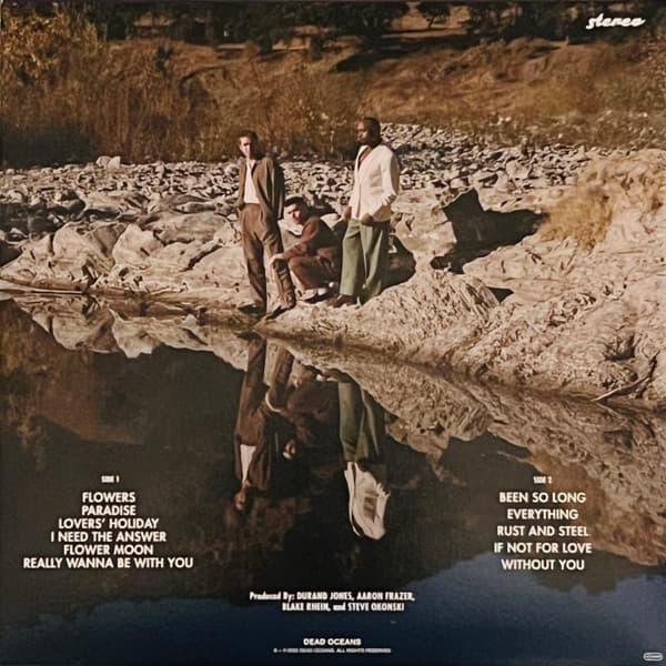 Album cover with three people by a river, featuring text and production credits.