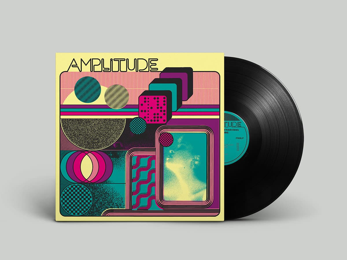 Vinyl record with a colorful 'Amplitude' cover on a gray background