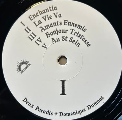 Vinyl record label with text and a logo on a black background