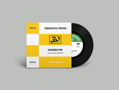 Vinyl record with a yellow and white cover on a gray background