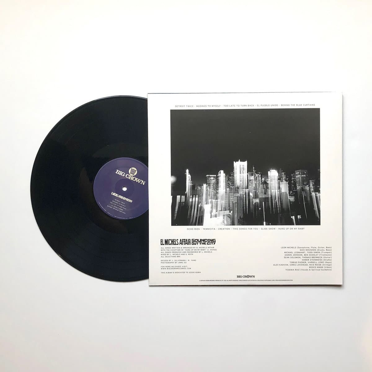 Vinyl record with a cityscape cover on a white background