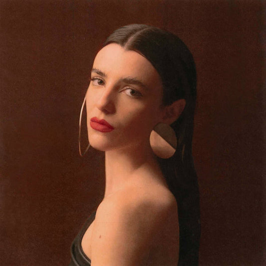 Cover art for Nina Maia - Inteira, featuring a close up photo of a woman against a brown background.
