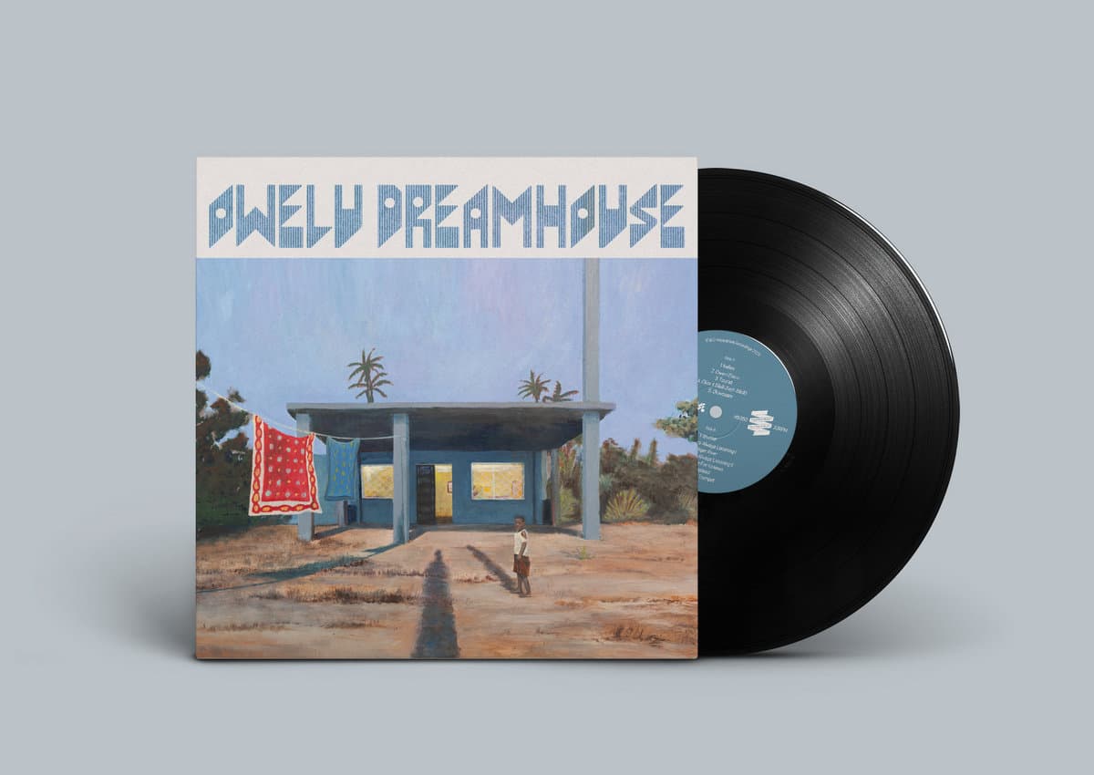 Vinyl record with a cover featuring a building and palm trees on a gray background
