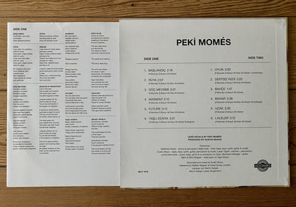 Vinyl record sleeve with track listings on a wooden surface