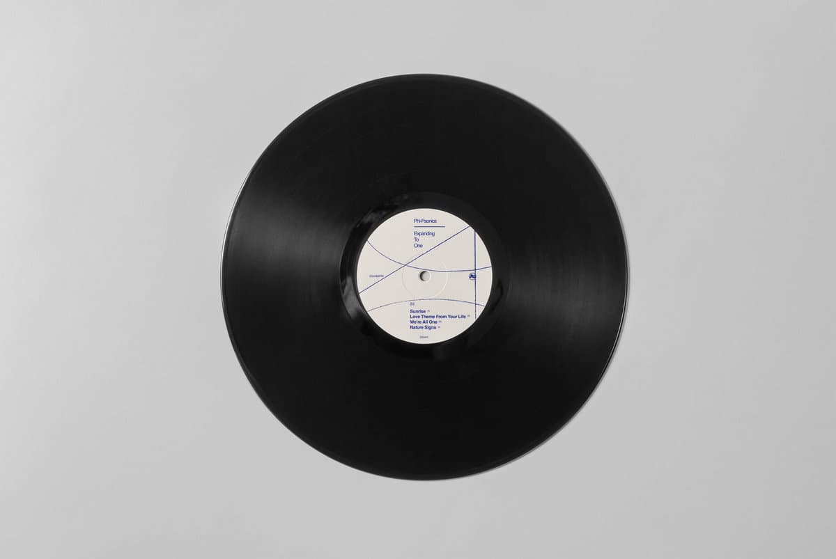 Close up of black vinyl for Phi-Sonics - Expanding as one, with a white label and blue text.