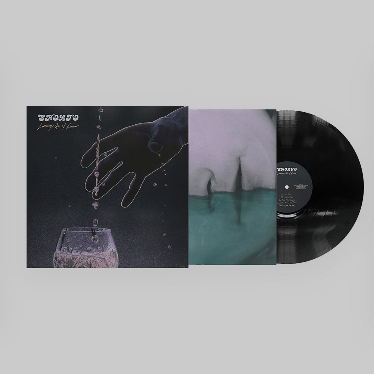 Vinyl record with artistic cover featuring a hand and abstract elements on a gray background