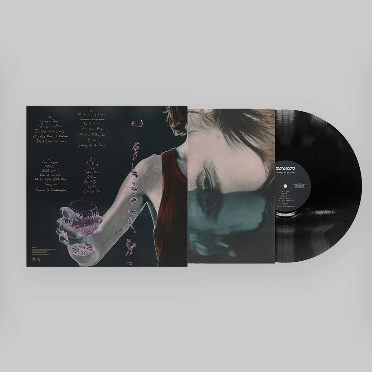 Vinyl record with artistic cover design on a white background