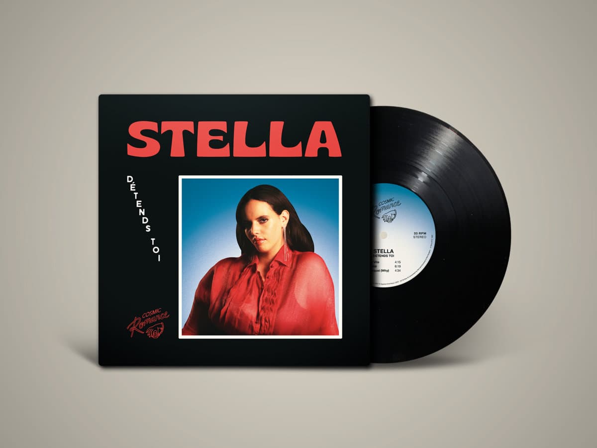 Vinyl record with cover featuring a woman in a red shirt on a beige background