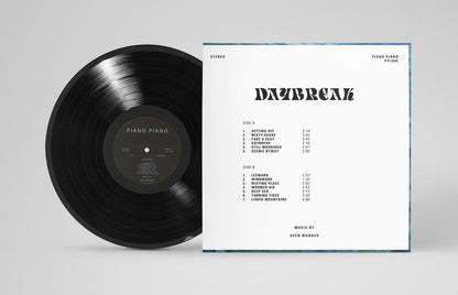 Vinyl record with cover displaying album details on a gray background