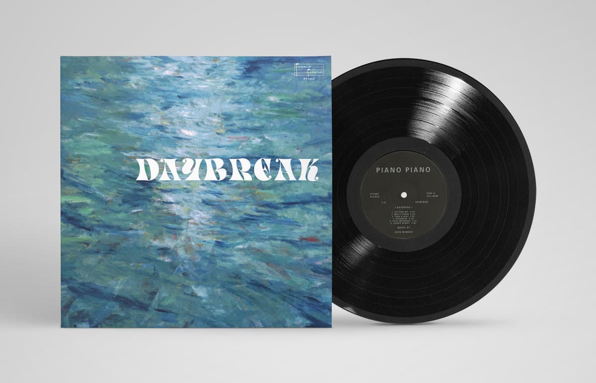 Vinyl record with a blue abstract cover and 'Daybreak' text on a gray background