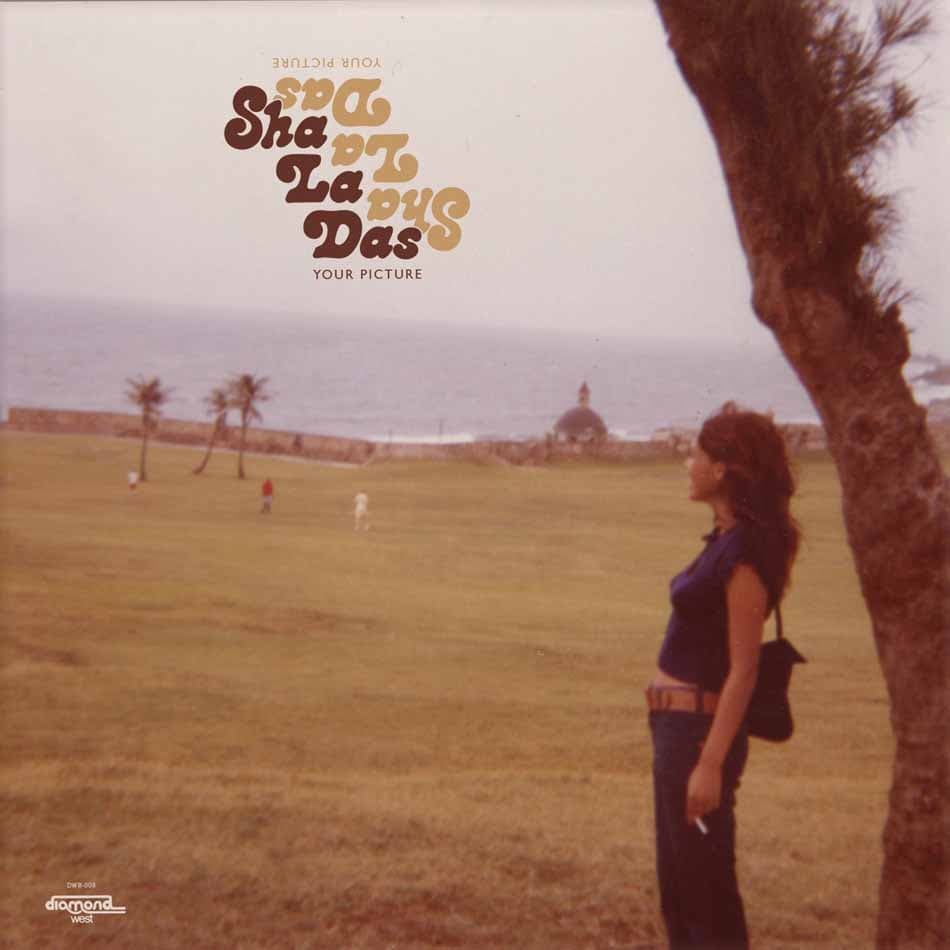 Album cover with a person standing in a field, palm trees, and text overlay.