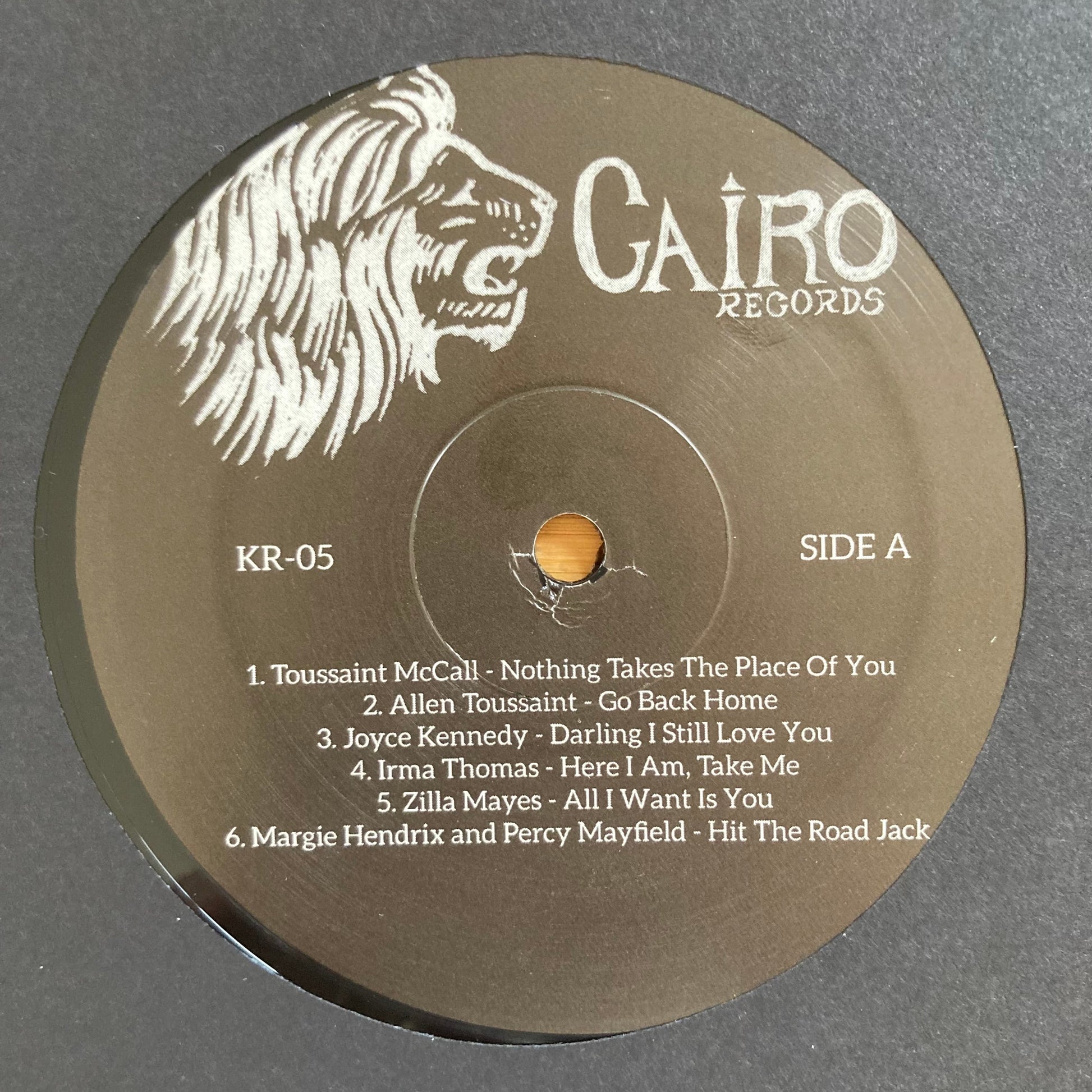 Vinyl label, side A, for “The World Is a Cafeteria” 2LP soul compilation by Cairo Records. Gold foil detail, white sleeves, deluxe packaging with booklet.