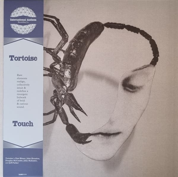 Cover art for Tortoise - Touch featuring a black and white pencil sketch of a face and a scorpion and a blue obi strip with International Anthem logo and album tracklist