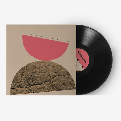 Vinyl record with a unique cover design featuring abstract shapes on a white background